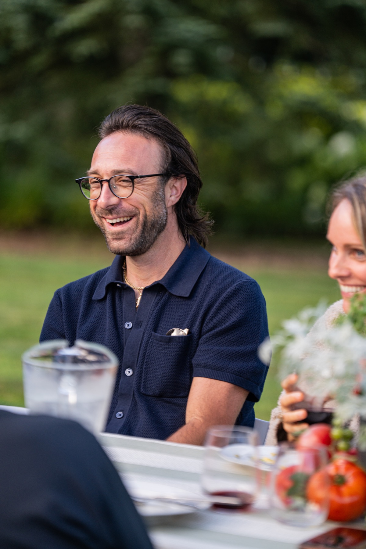 A guest laughing during the outdoor dinner