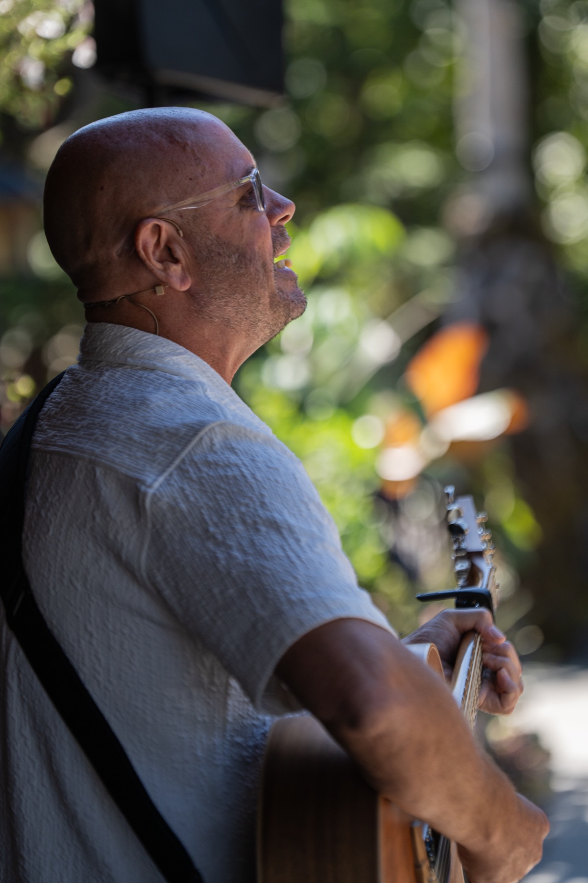 A musician performing outdoors for guests